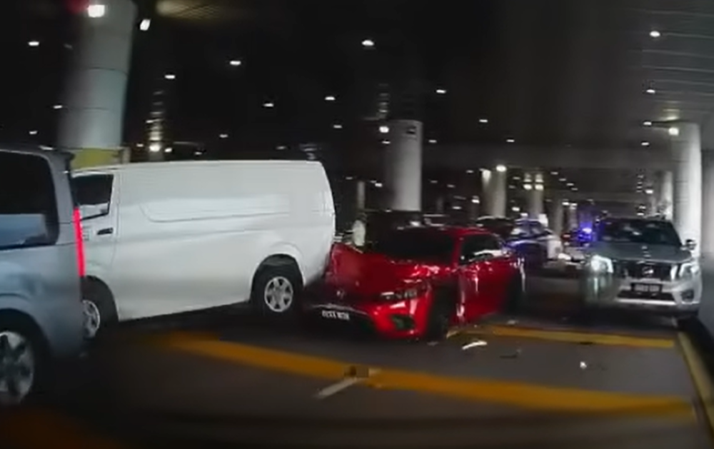 A screenshot from a viral video shows the police chasing a red Honda Civic at KLIA yesterday. — Picture via social media