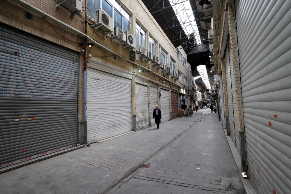 A man walks past closed shops at the Grand Bazaar in Tehran on March 30, 2026. — AFP pic