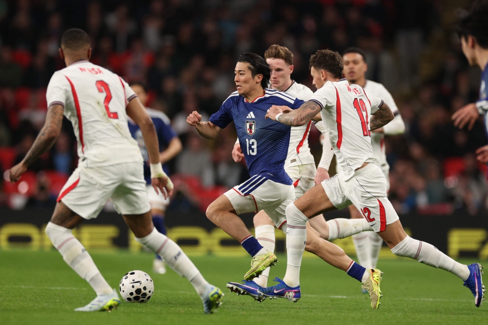 Japan’s midfielder Keito Nakamura runs through the England defence during the friendly international football match between England and Japan at Wembley Stadium in London on March 31, 2026. — AFP pic