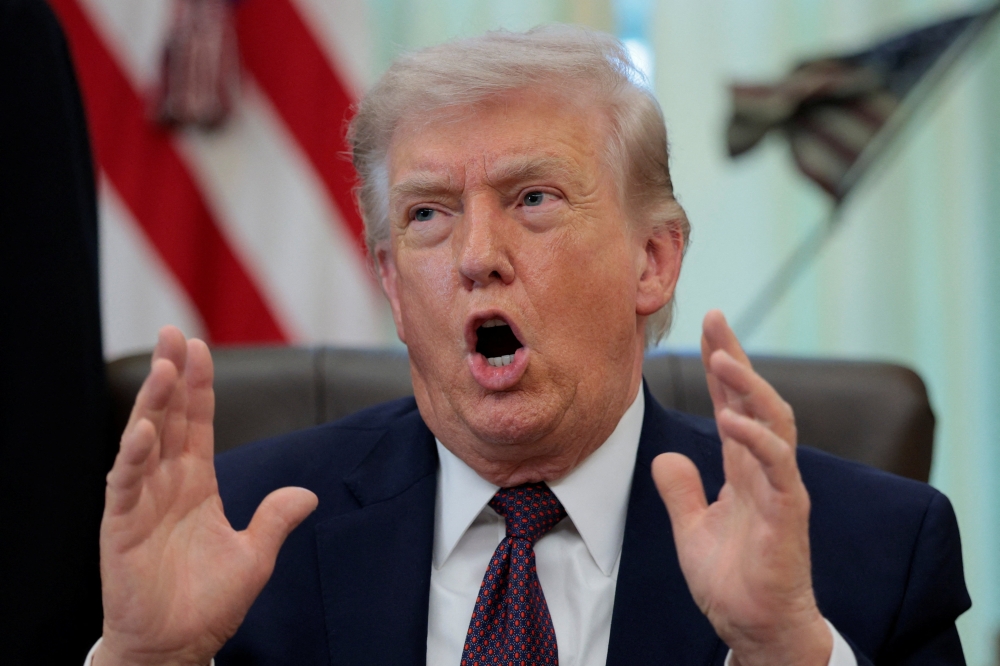 US President Donald Trump speaks during the signing ceremony for an executive order on mail ballots in the Oval Office of the White House in Washington, DC on March 31, 2026. — Reuters pic
