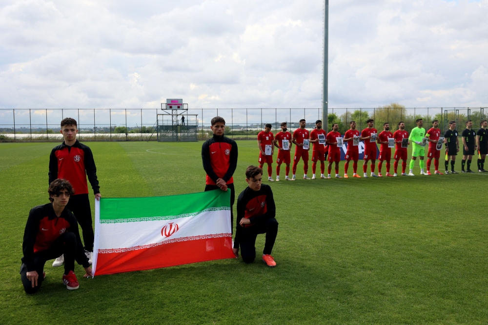 Iran’s national team players pose for photographers holding pictures of children allegedly killed in a US strikes in Iran, prior a friendly football match between Iran and Costa Rica, in Antaalya, southern Turkey, on March 31, 2026. — AFP pic