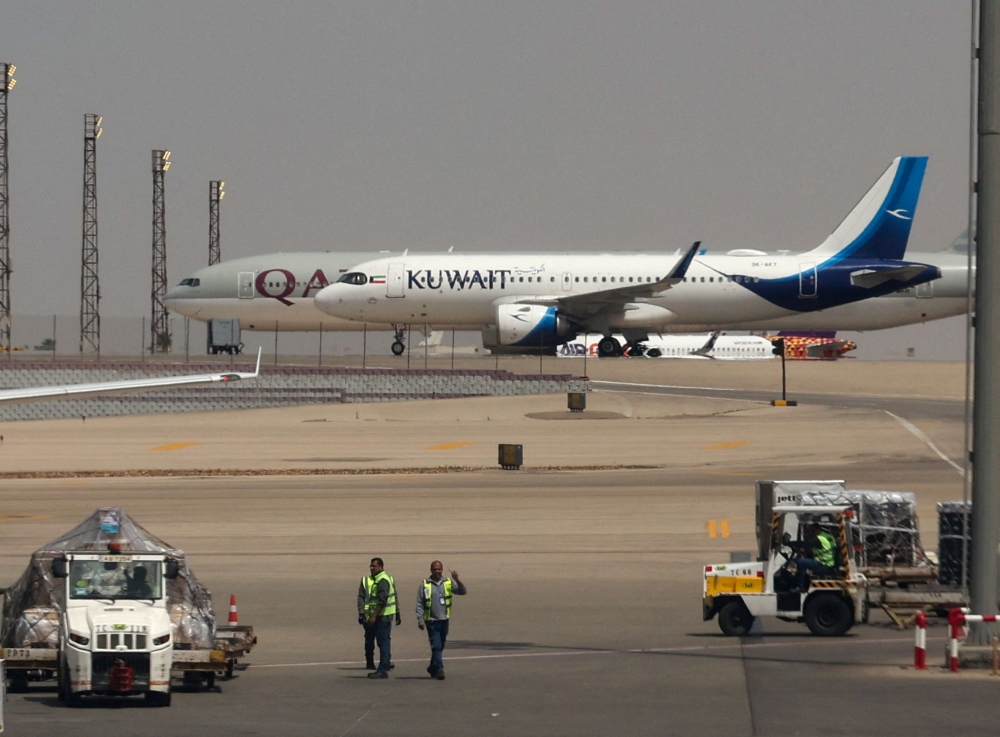 Planes of Kuwait Airways and Qatar Airways are seen through the window of a Middle East Airlines aircraft at Cairo International Airport, amid the US-Israeli conflict with Iran, in Cairo, Egypt, March 31, 2026. — Reuters pic