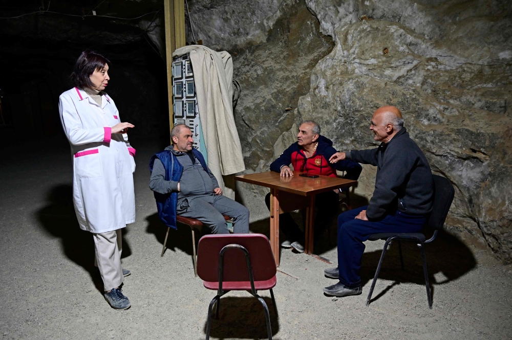 Doctor Anush Voskanyan (L) speaks to patients of the Republican Centre of Speleotherapy, the 4,000 square metres salt cave clinic carved into the Avan grey salt mine at a depth of 235 metres and operating since 1987, on the outskirts of Yerevan on February 5, 2026. — AFP pic