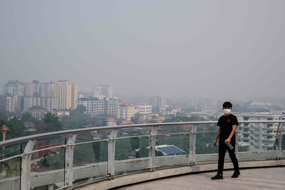 A man wears a face mask on a heavily polluted day in Chiang Mai April 2, 2026. — AFP pic