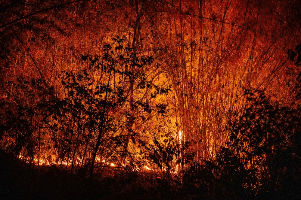 A hillside wildfire is seen from a road in Chiang Mai April 1, 2026. — AFP pic