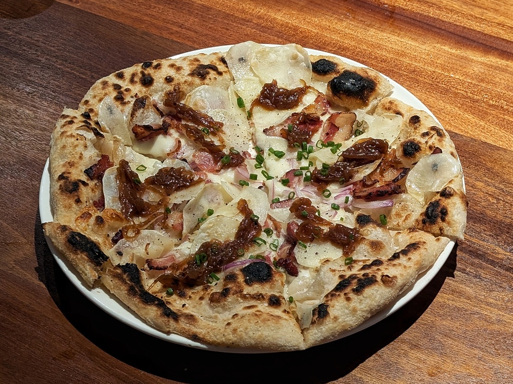 The PB&J pizza has nothing to do with peanut butter and jelly; instead, it features potatoes, bacon and onion jam. — Picture by Ethan Lau