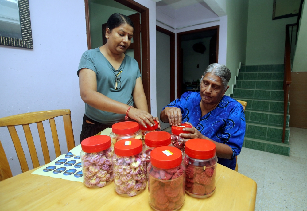 Indira is seen here in 2020 with the cookies she baked to earn extra income for Deepavali. — File picture by Farhan Najib