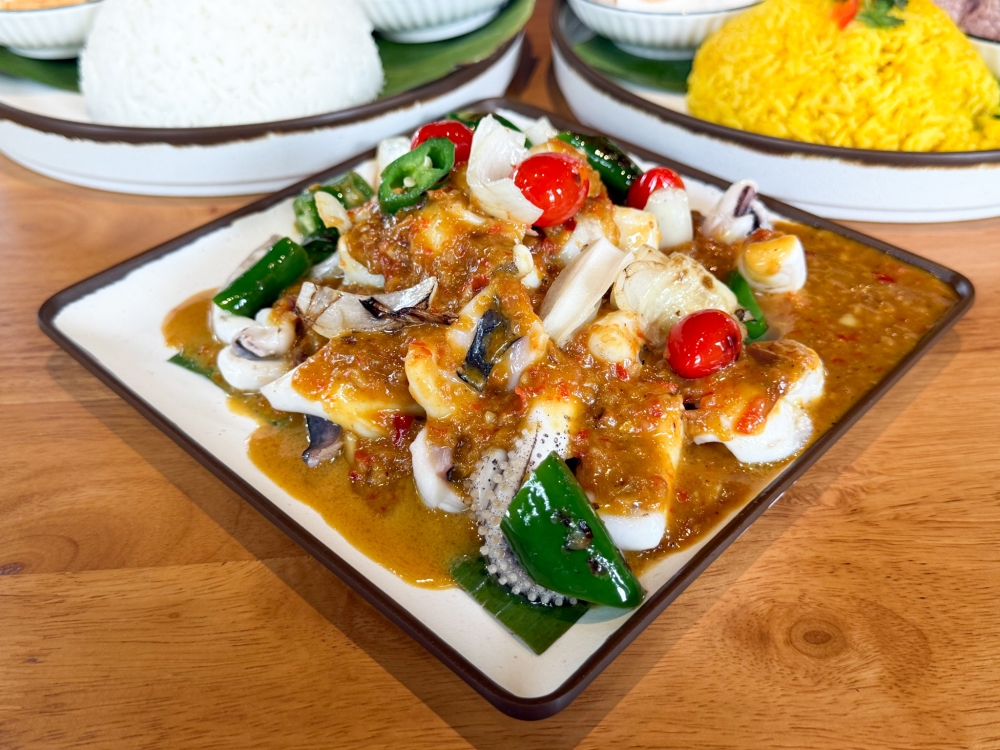 Grilled Sotong Katak features perfectly cooked squid paired with a creamy, savoury peanut sauce. — Picture by Lee Khang Yi