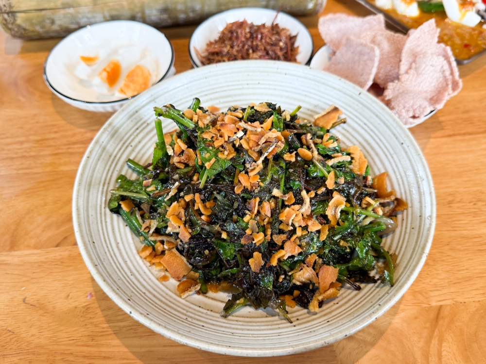 Pucuk Paku with Ikan Masin Tenggiri isn’t your typical boring plate of greens as the tender stems and young leaves are packed with smoky flavours. — Picture by Lee Khang Yi