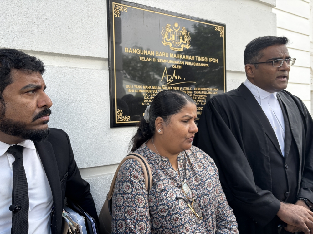 M. Indira Gandhi (centre), her lawyer Rajesh Nagarajan (right) and Indira Gandhi Action Team (Ingat) chief Arun Dorasamy (left) speak to reporters at the High Court in Ipoh April 6, 2026. — Picture by John Bunyan
