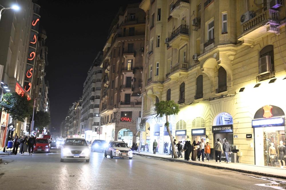 People walk before the closing of shops in downtown Cairo on April 2, 2026. — AFP pic