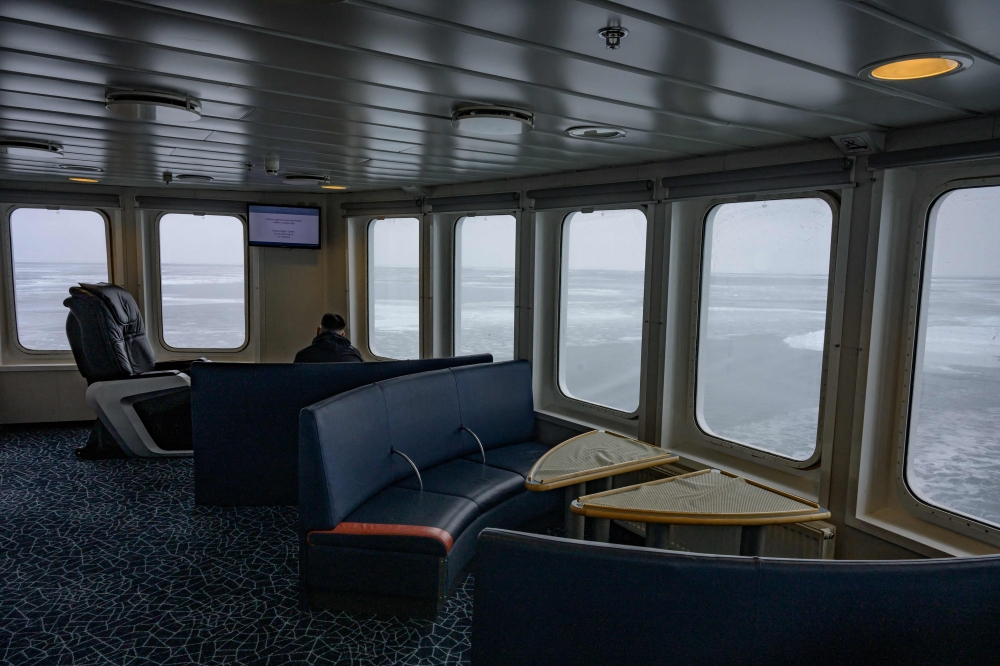A man looks out at the frozen sea from the aft deck of the Sarfaq Ittuk ferry in Disko Bay, not far from Ilulissat, Greenland, on March 15, 2026. — AFP pic 
