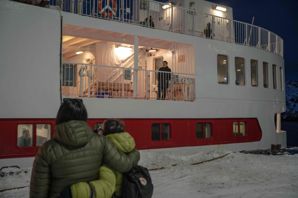 People watch from the ground as their loved ones board the Sarfaq Ittuk ferry at the port of Nuuk, Greenland, on March 13, 2026. — AFP pic 