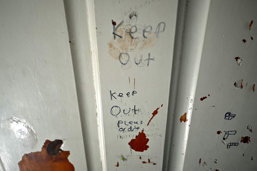 Scribbles on the bedroom door of British singer David Bowie where he spent 13 years of his life, is pictured at the house he once lived in, in Bromley, south-east of London. — AFP pic