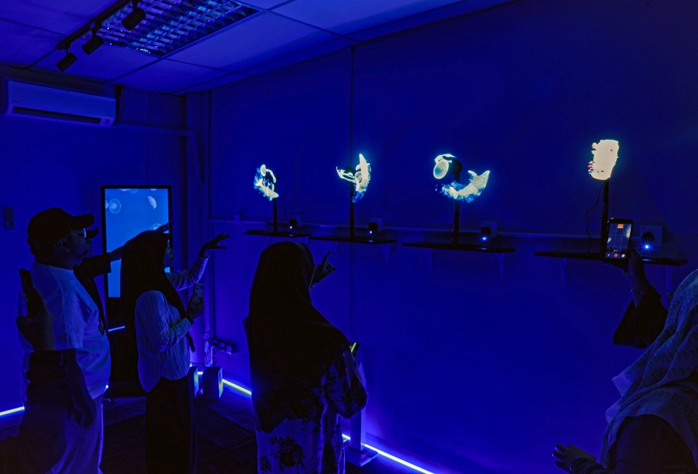 Visitors explore exhibits at the Johor Marine Park Gallery in Mersing, set up by the Department of Fisheries to raise awareness of marine ecosystem conservation. — Bernama pic