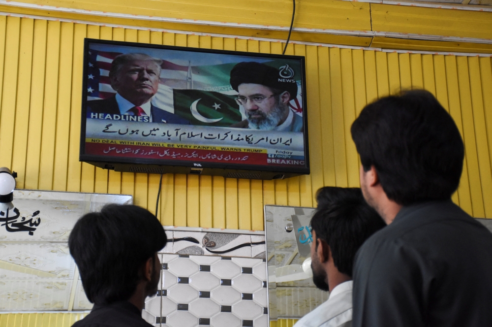 People watch a local channel at a barber shop in Islamabad. The author argues that the war has ultimately served the interests of defence industries, oil markets and political elites rather than ordinary people, exposing how conflict is driven less by ideals like peace or security than by profit and power. — Reuters pic