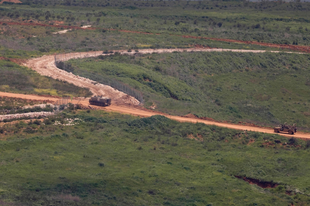 Israeli military vehicles drive along the road in southern Lebanon, near the Israeli border on April 10, 2026. The Israeli military said on Friday that it had ‘dismantled’ more than 4,300 Hezbollah sites in Lebanon since fighting with the militant group began last month. — AFP pic