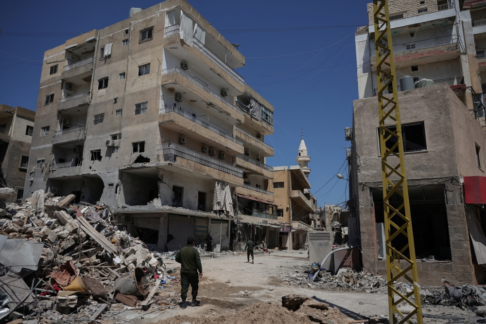 A municipality police officer walks in an area damaged during Israeli strikes on Wednesday, in Tyre, south Lebanon, April 11, 2026. — Reuters pic  