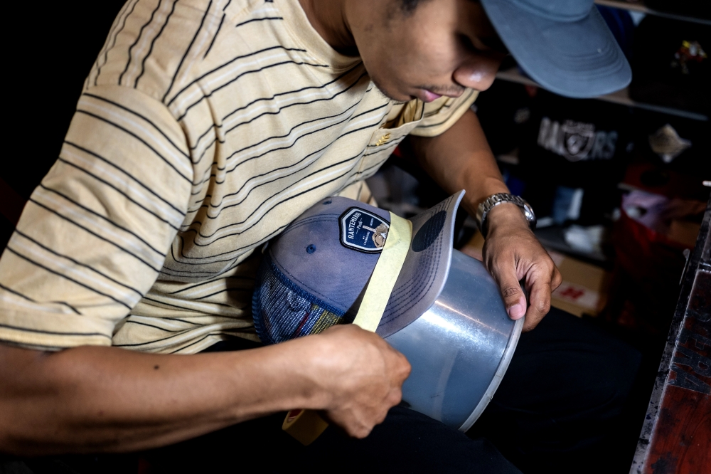 Hat restoration entrepreneur Ahmad Fadhil Nazeri, 29, during an interview in Wangsa Maju, Kuala Lumpur, recently. — Bernama pic