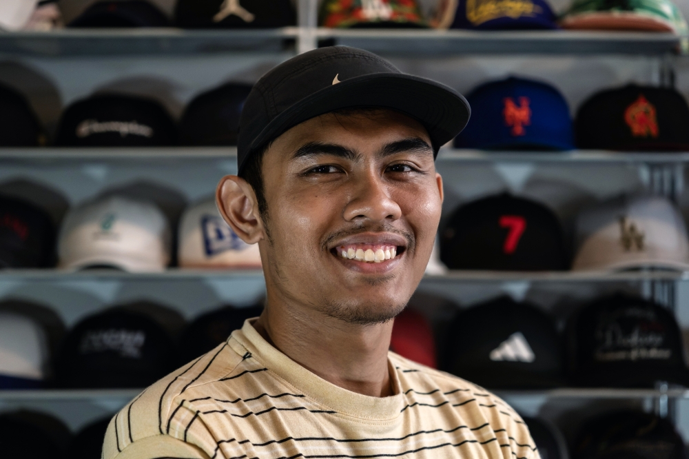 Hat restoration entrepreneur Ahmad Fadhil Nazeri, 29, at his shop in Wangsa Maju, Kuala Lumpur, recently. — Bernama pic 