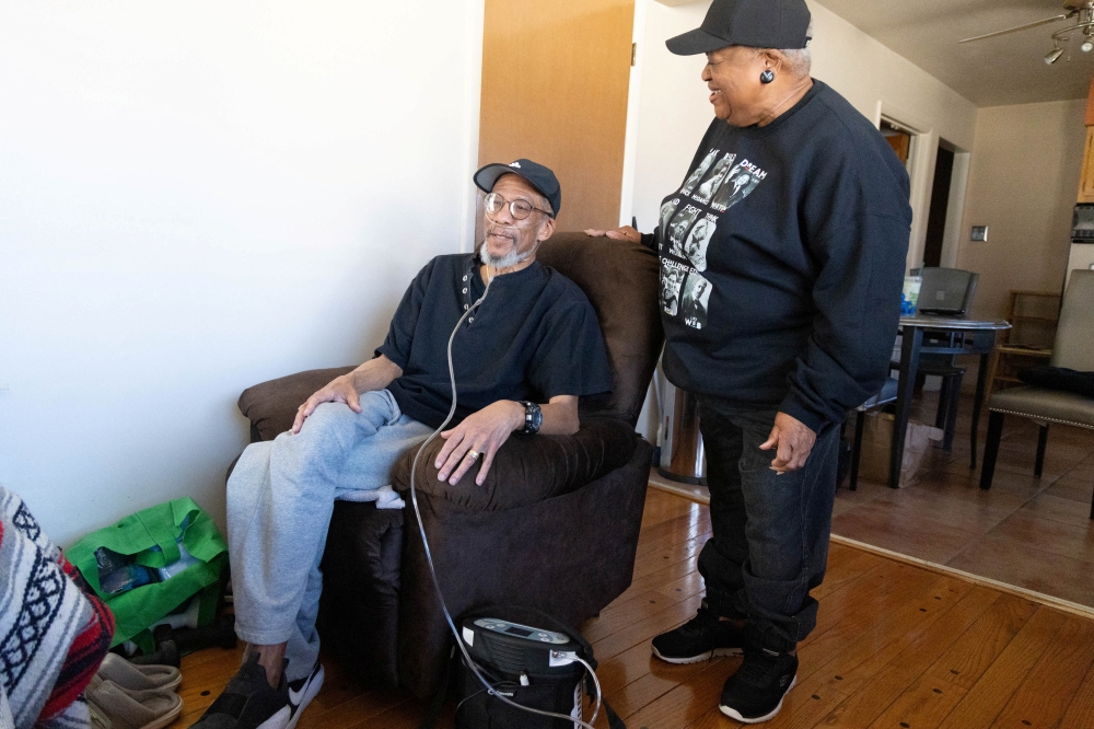 Barbara Johnson stands beside her husband as he uses an oxygen concentrator inside their home in Florissant, Missouri, US, February 18, 2026. — Reuters pic