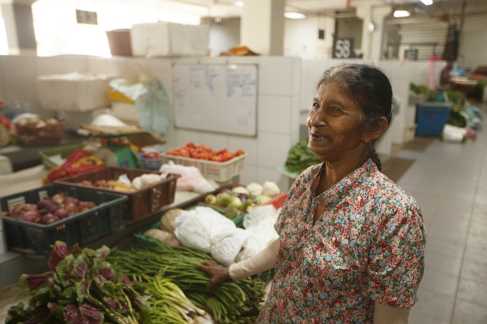 Vegetable vendor Uma Pathy Marutapa is already bracing for a possible vegetable price hike if fuel prices continue to soar. — Picture by Raymond Manuel