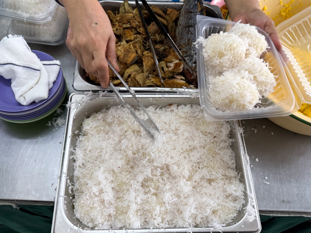 Pulut Gaul Nyior mixes soft glutinous rice balls topped with the fluffiest grated coconut and paired with salted fish and ‘ikan tongkol’. — Picture by Lee Khang Yi