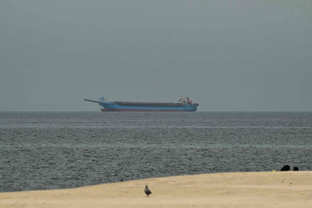 A ship is seen in the Persian Gulf off the coast of Sharjah the day after the failure of US-Iran peace talks on April 13, 2026. — AFP pic
