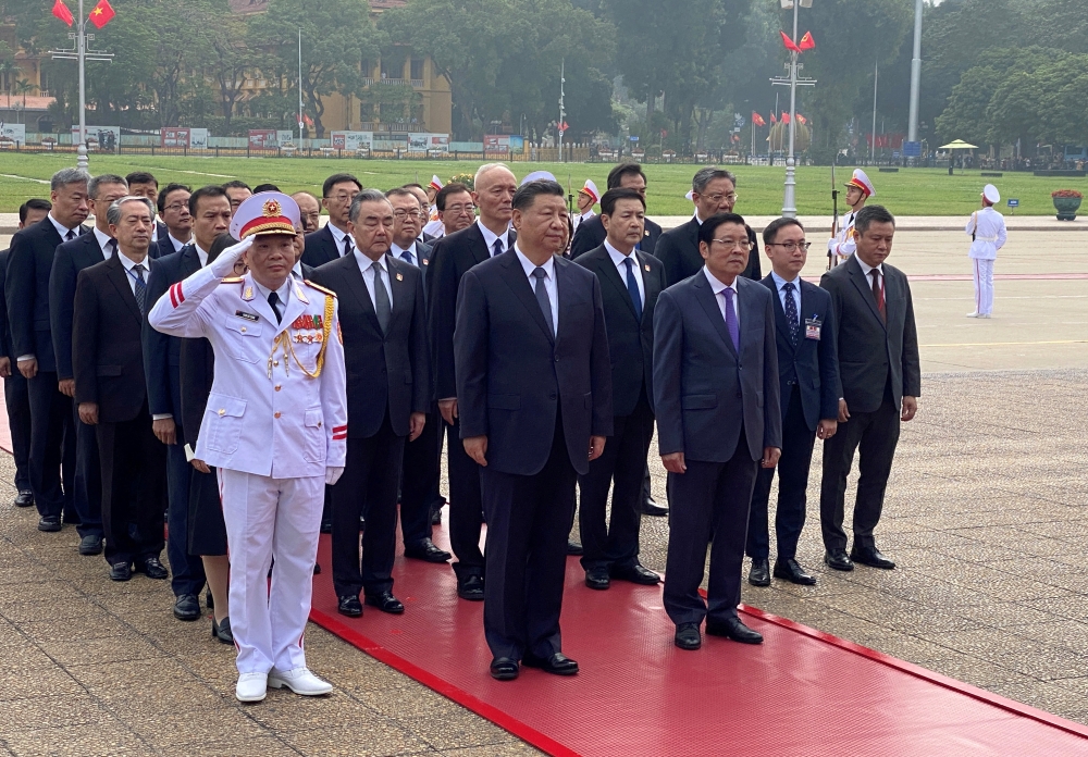 Chinese President Xi Jinping attends a wreath-laying ceremony at the Ho Chi Minh mausoleum during a two-day state visit to Hanoi on December 13, 2023. — Reuters pic