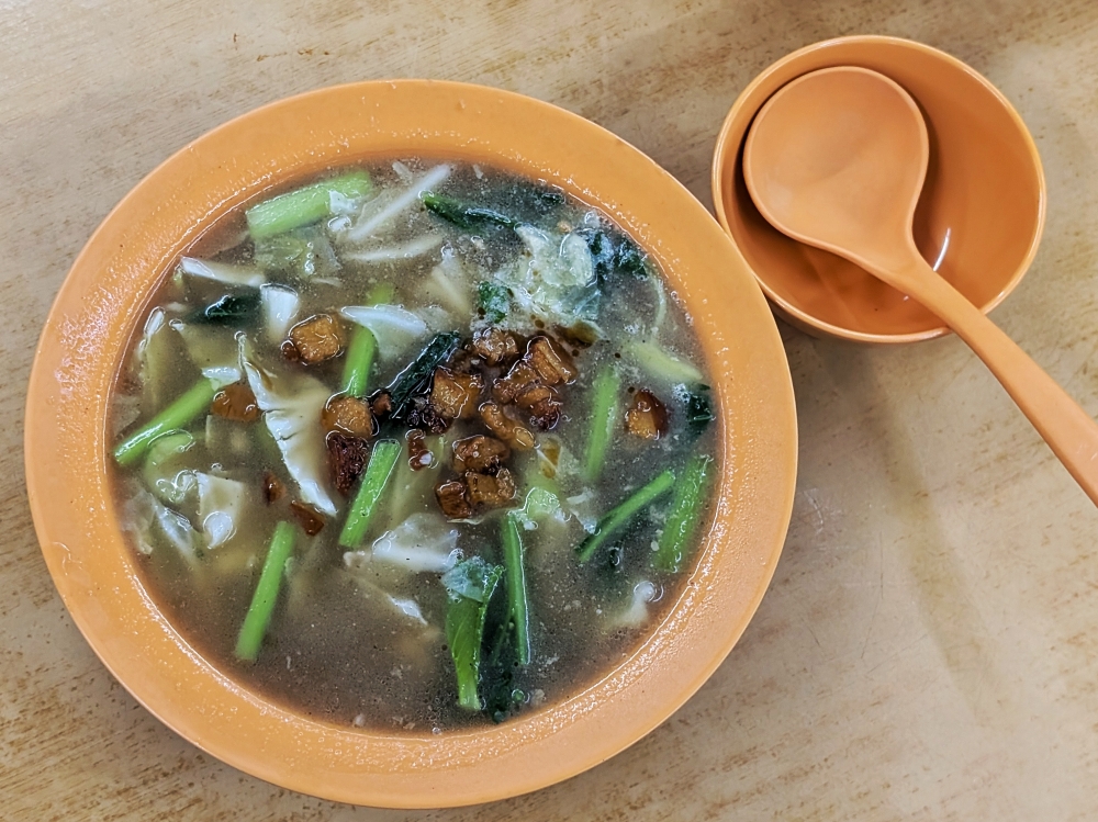 Hungry during the wait? Try the pork soup, which is generously topped with even more pork lard. — Picture by Ethan Lau