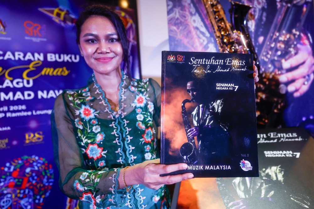 Tan Sri Ahmad Nawab’s granddaughter Teh Suraya Nasir Khan poses with a book at the Tan Sri Ahmad Nawab’s ‘Sentuhan Emas Lagu Lagu’ book launch ceremony at Saloma Kuala Lumpur April 16, 2026. — Bernama pic