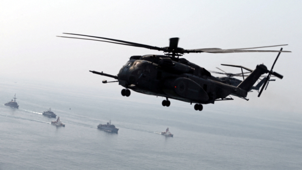 A U.S. Navy MH-53E Sea Dragon helicopter flies over U.S. and U.K. Navy ships during a Mine Countermeasures Exercise (MCMEX) in the Arabian Sea on September 10, 2018. — Reuters pic