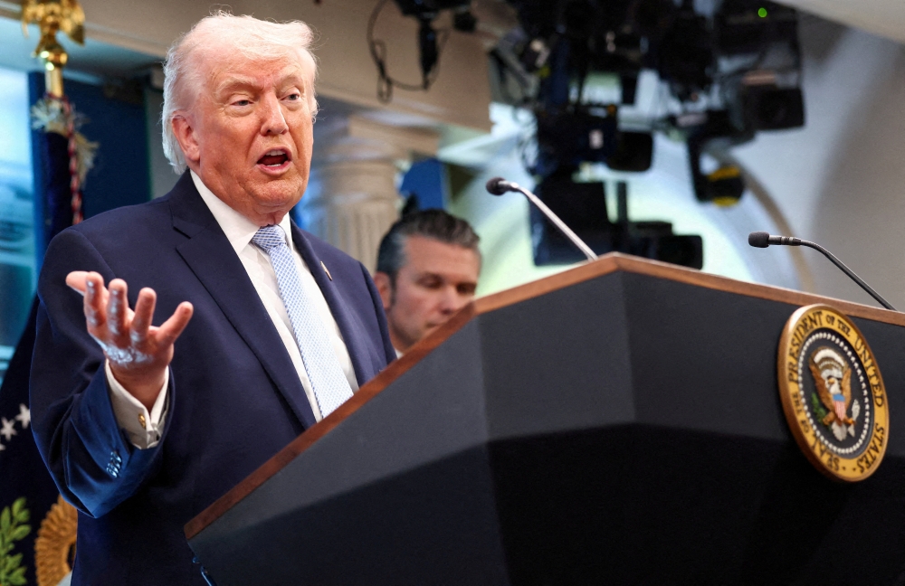 U.S. President Donald Trump, flanked by Secretary of Defense Pete Hegseth, speaks during a press conference in the James S. Brady Press Briefing Room at the White House in Washington, D.C. on April 6, 2026. — Reuters pic