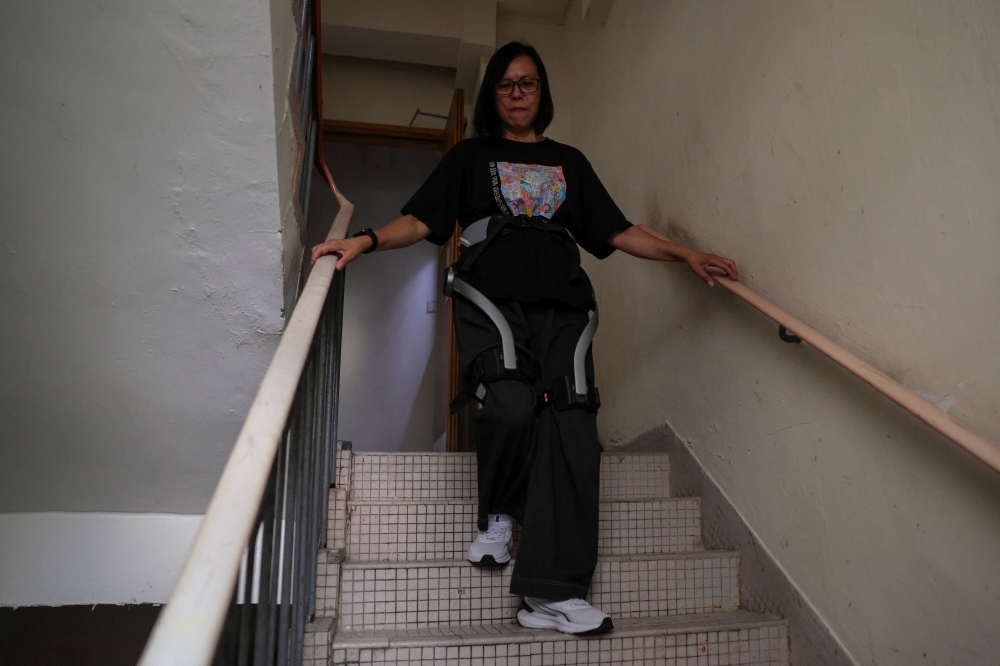 ‘I don’t have the strength’: How robotic legs are helping Hong Kong fire survivors climb home
