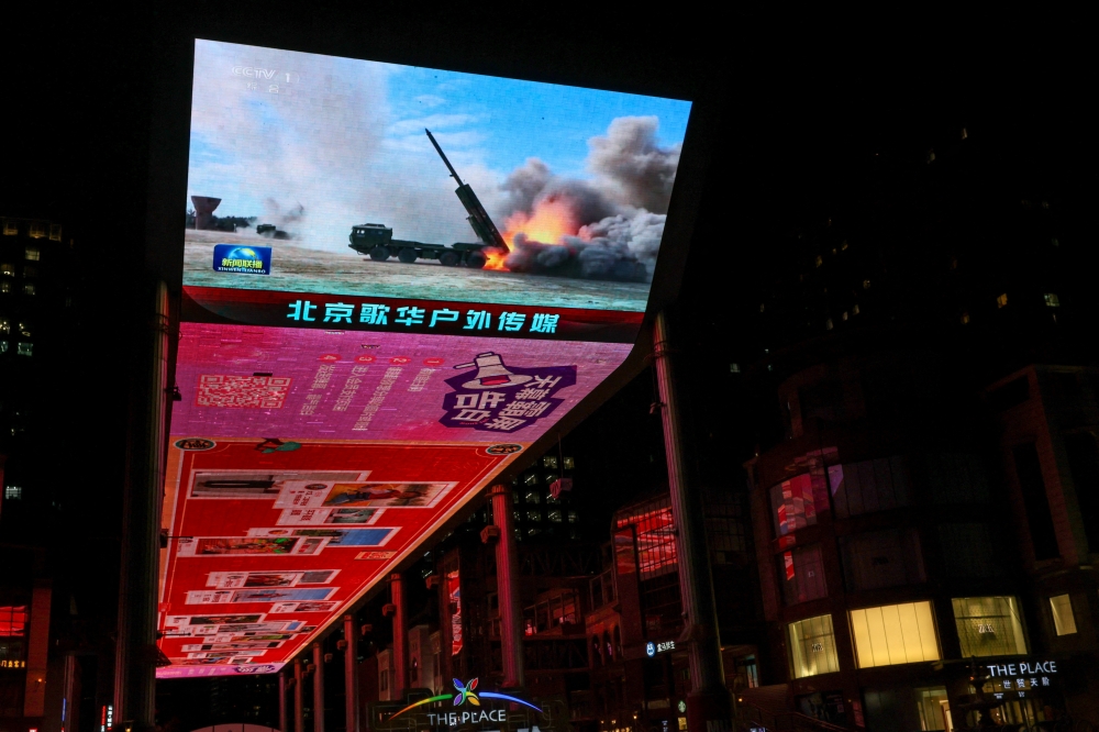 A giant screen shows a news report on China’s ‘Justice Mission 2025’ military drills around Taiwan, in Beijing December 30, 2025. — Reuters pic