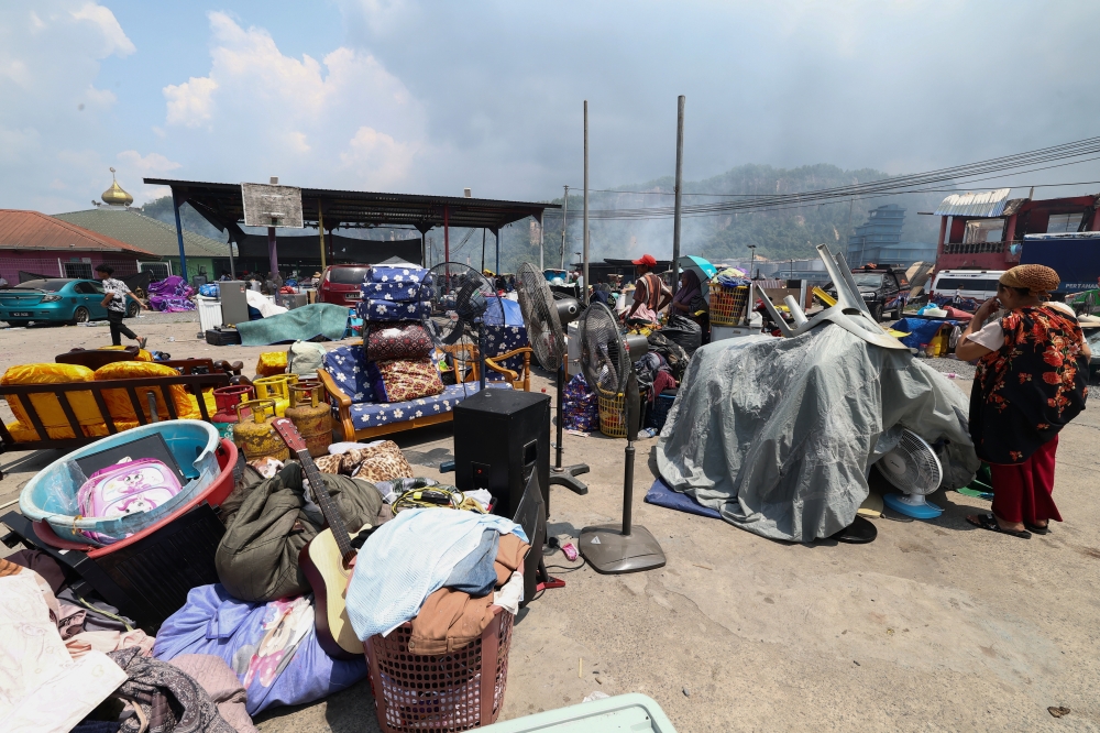 Some residents placed household appliances that were successfully rescued from a fire in an open area in Kampung Bahagia, Sandakan April 19, 2026. — Bernama pic