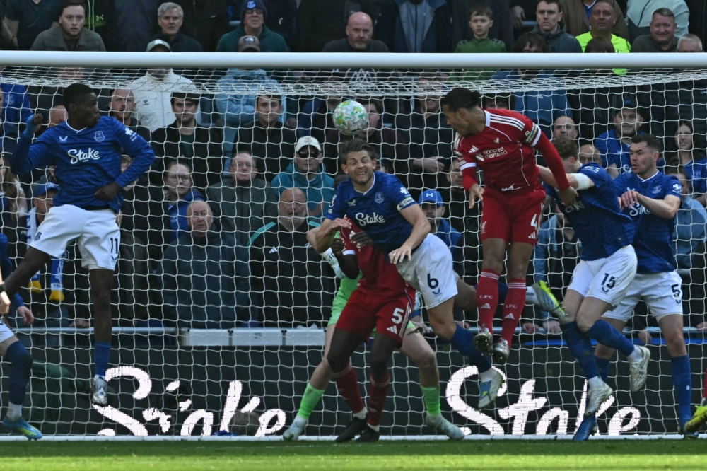 Liverpool’s Virgil van Dijk scores their late second goal during the Premier League match with Everton at Hill Dickinson Stadium in Liverpool April 19, 2026. — AFP pic