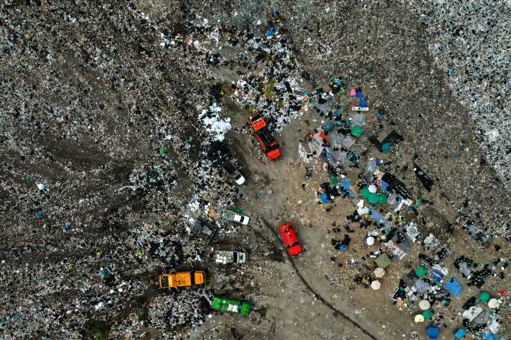 Plastic pollution, such as waste choking oceans and landfills filling up, is cited as a visible symptom of the ‘take-make-dispose’ linear economic model that the article warns is putting both planetary stability and economic resilience under strain. — Reuters pic