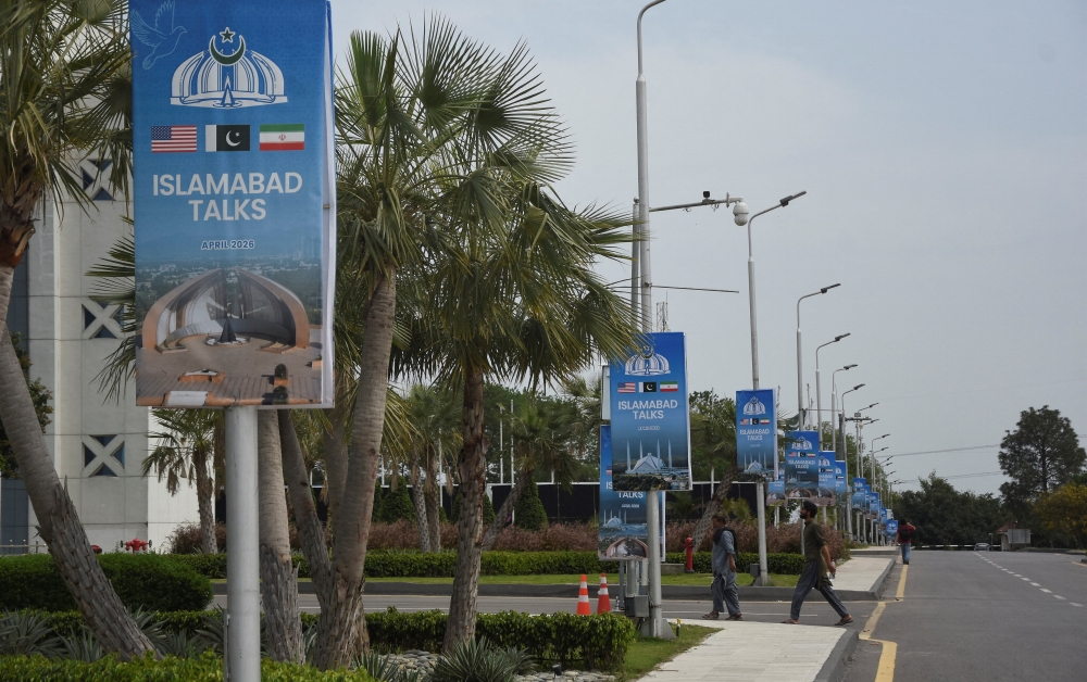 Hoardings displaying flags of the US, Pakistan and Iran, as Pakistan prepares to host the US and Iran for the second phase of peace talks in Islamabad April 18, 2026. In the short term, Iran wants access to limited frozen funds overseas. Broader sanctions relief would come later and require European buy-in, diplomats said, as Iranian leaders see European trade as critical over the long term. — Reuters pic 