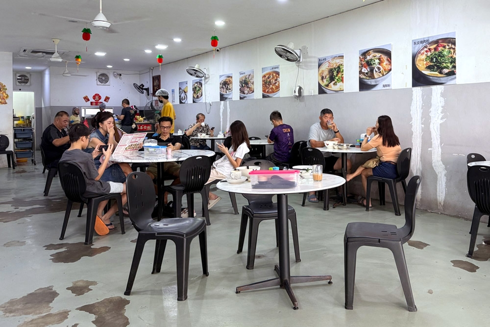 Customers enjoying their bowls of pork noodles. — Picture by CK Lim    