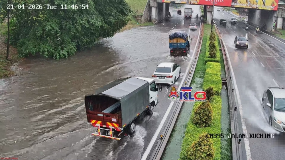 Vehicles drive through floodwaters along Jalan Kuching in Kuala Lumpur after heavy rain. — Picture via Facebook/dbklklccc