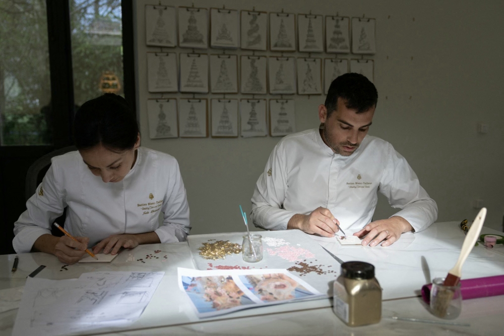 The creations of the French celebrity pastry chef Bastien Blanc-Tailleur (right) are to cakes what Haute Couture is to fashion: one-off, hand-made, and requiring extraordinary investments in time and money. — AFP pic