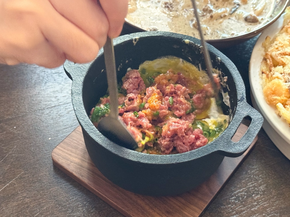 Once it hits the table, mix the egg yolk with the rice to combine everything inside the stone bowl. — Picture by Lee Khang Yi