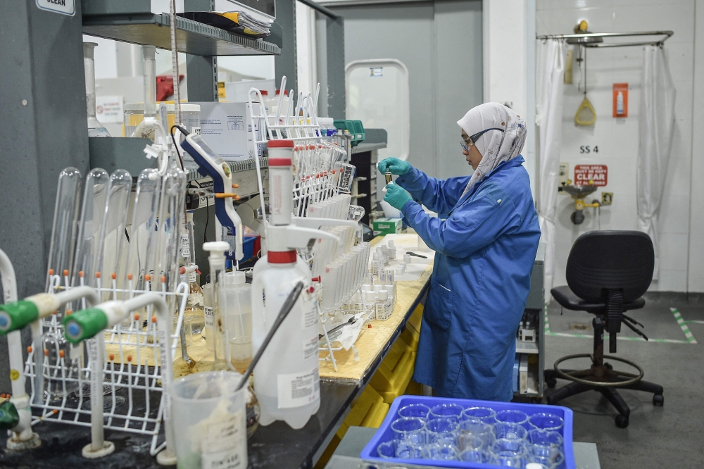An employee wearing protective gear works in a laboratory during a visit of the facility of Australian mining firm Lynas in eastern Malaysia’s Gebeng on April 8, 2026. — AFP pic