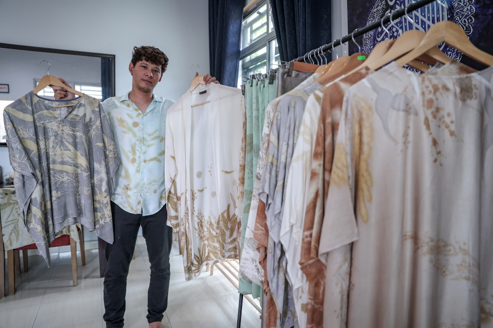 Entrepreneur Misbaahussalam Zakaria shows off some of the products he produces using eco-printing techniques at his home in Benut, Pontian April 23, 2026. — Bernama pic