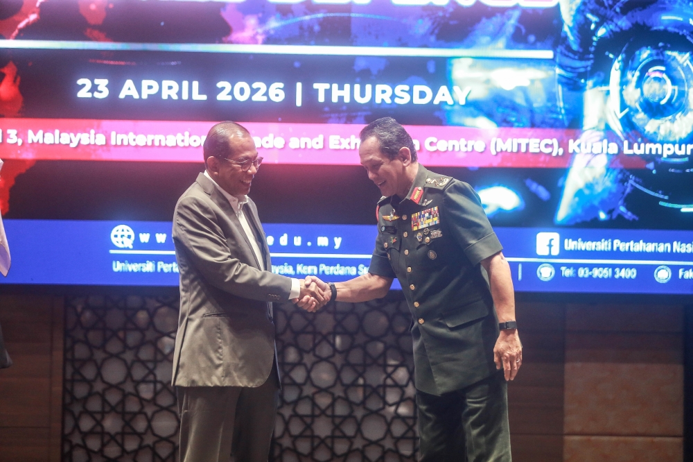 Defence Minister Datuk Seri Mohamed Khaled Nordin (left) is greeted by UPNM vice-chancellor Lt General Datuk Arman Rumaizi Ahmad (right) at the forum on April 23, 2026. — Picture by Sayuti Zainudin