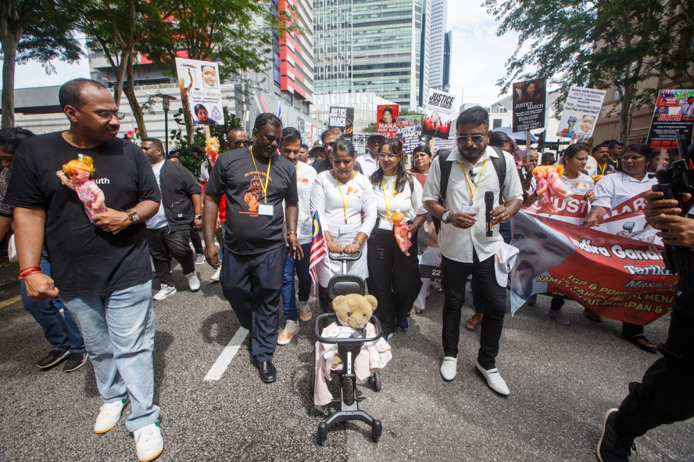 Indira, seen together with a teddy bear that belonged to Prasana as a baby, walked in the ‘March for Justice’ from Sogo Kuala Lumpur to Bukit Aman in November 2025 to get the Inspector-General of Police’s help to recover Prasana. — Picture by Raymond Manuel