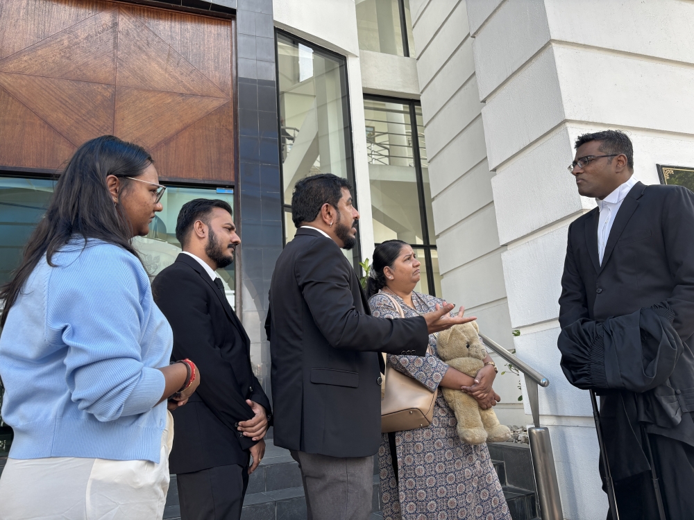 M. Indira Gandhi (2nd right) with her children Karan Dinish (2nd left) and Tevi Darsiny (far left), lawyer Rajesh Nagarajan (far right) and Indira Gandhi Action Team (Ingat) chief Arun Dorasamy (centre) at the High Court in Ipoh April 6, 2026. — Picture by John Bunyan