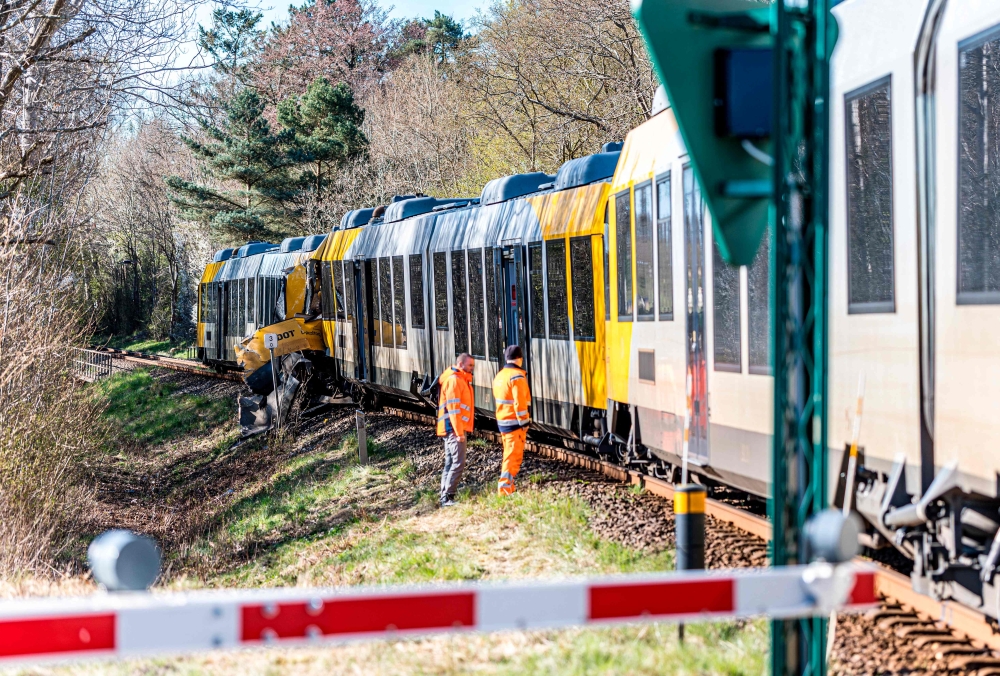 Rescue personnel stand at the site where two trains collided between the towns of Hillerod and Kagerup, north of Copenhagen, leaving many injured, on April 23, 2026.  — Steven Knap/Ritzau Scanpix/AFP pic