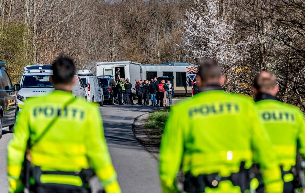 Rescue personnel stand near the site where two trains collided between the towns of Hillerod and Kagerup, north of Copenhagen, leaving many injured, on April 23, 2026. — Steven Knap/Ritzau Scanpix/AFP pic
